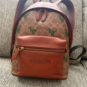 Coach Rexy Medium Backpack with Green Dino Print and Rust Leather